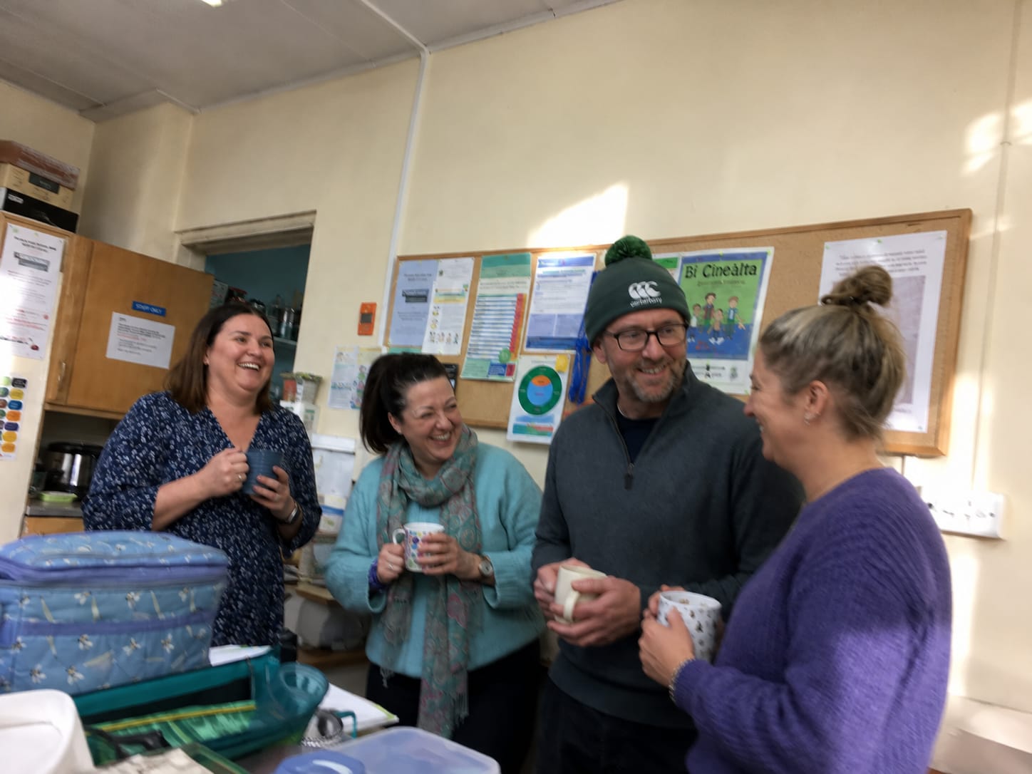 Teachers discussing the curriculum change over tea in the staffroom