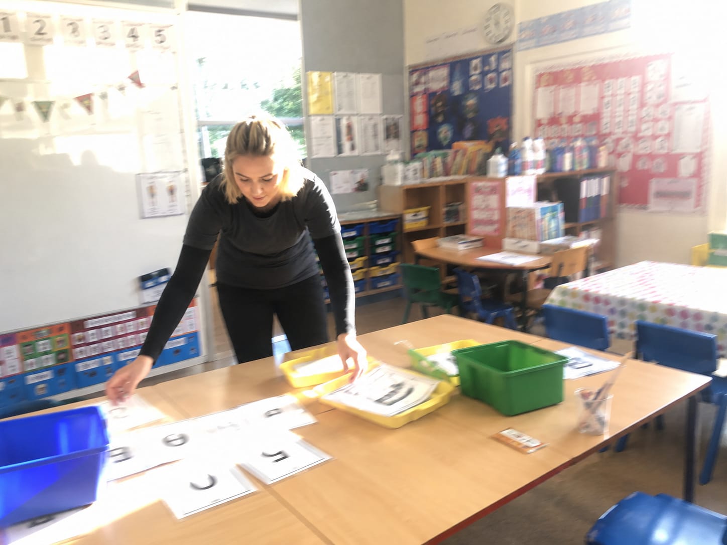 A teacher organising her classroom resources for the new curriculum