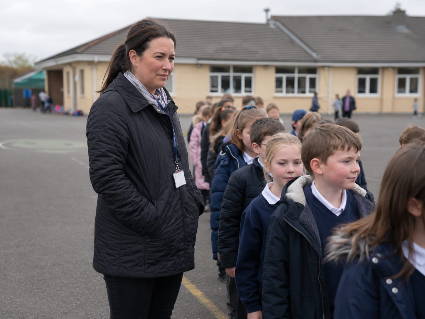 A teacher supporting her class in the schoolyard